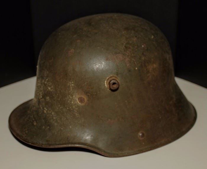 This is a World War 1 Stahlhelm. This is the M1916 version and was the one used in World War 1. The WW1 version had a few differences from the WW2 version. First, the Stahlhelm had 2 studs on the sides. The studs were used to attach extra  armor to the front, but it was too bulky and heavy for regular use, so they were removed.
