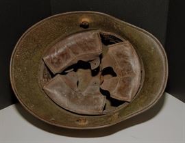 This is a World War 1 Stahlhelm. This is the M1916 version and was the one used in World War 1. The WW1 version had a few differences from the WW2 version. First, the Stahlhelm had 2 studs on the sides. The studs were used to attach extra armor to the front, but it was too bulky and heavy for regular use, so they were removed.