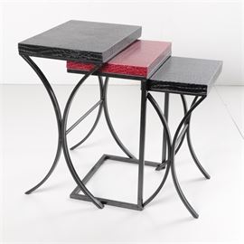 Set of Three Alligator Textured Nested Tables in Black and Red: A set of three nested tables, each having rectangular tops with alligator texture. Two have black tops, over curvilinear metal frames. The middle table differs, having a red top and cantilevered frame. Early 21st century.