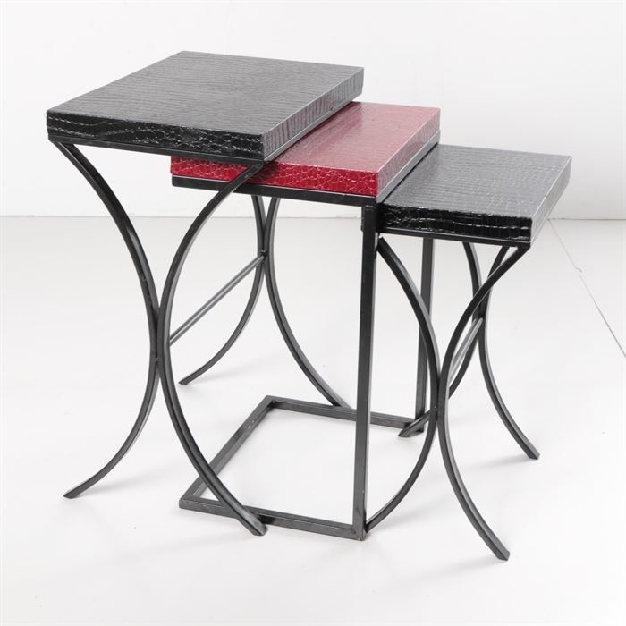 Set of Three Alligator Textured Nested Tables in Black and Red: A set of three nested tables, each having rectangular tops with alligator texture. Two have black tops, over curvilinear metal frames. The middle table differs, having a red top and cantilevered frame. Early 21st century.
