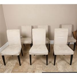 Set of Contemporary Dining Chairs: A set of contemporary dining chairs. These chairs feature a rectangular back over a square seat that rises above tapered legs. The chairs are unmarked.