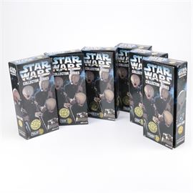 Star Wars Cantina Band Action Figure Set: A collection of “Collector Series” action figures from the maker Kenner. These pieces are in the form of the Catina band member Figrin D’an, Nalan, Tech, Ickabel, Tedn and Nalan from the Star Wars franchise. The figures are in the original packaging.
