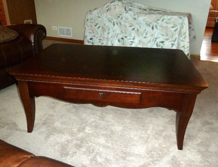 Large dark cherry coffee table with two drawers by Bassett.  48" x 32"