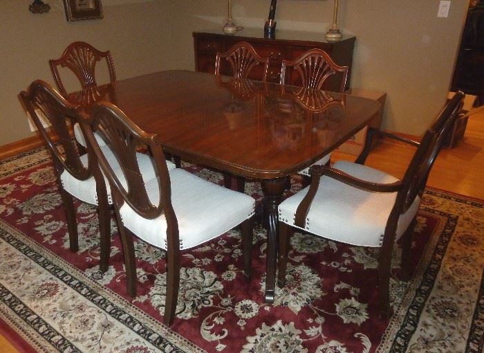 Vintage mahogany dining table, double pedestal, Duncan Phyfe style, with a custom glass top, plus full set of pads..  Four side chairs, two arm chairs, wheat sheaf  backs, cushioned seats.