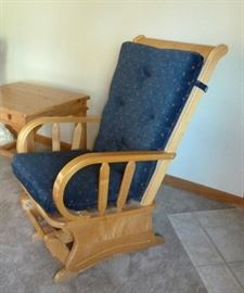 Solid wood platform glider with seat and back cushions.