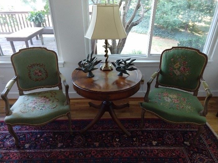 LOVE these hand embroidered French bergere armchairs making an Oreo out of a leather-topped mahogany drum table.