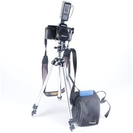 Nikon N50 Camera and Accessories: A Nikon N50 camera and accessories. This camera and accessory selection includes a Nikon N50 35mm SLR camera with a Nikon AF Nikkor 35-80 mm 1:4-5.6D lens and shoulder strap, a Sunpak auto 355 AF Thyridtor flash, a Yashica Pro-50 DX flash, a Kopil self timer, a metal tripod with telescopic legs and height adjust, various owner;s manuals and a black canvas storage bag with shoulder strap.