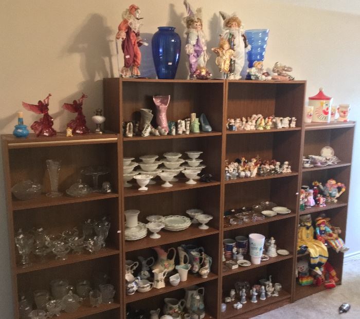 Hundreds of porcelain collectibles: salt & pepper shakers, button down shoes, porcelain clowns, vases, candle sticks, glasses, and more. 