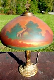 Choice Art Deco Reverse Painted Parlor Lamp.  
Forest scene with original painted base.  16” diameter shade.
