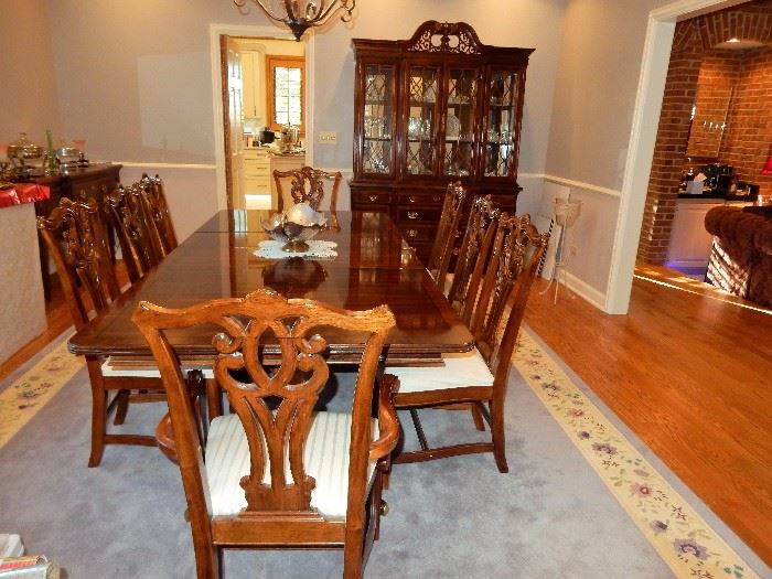 CHERRY WOOD FINISH ASIAN THEMED DINING ROOM SUITE  $1,800.00
INCLUDES, DINING TABLE (SHOWING WITH TWO LEAVES) 8 CHAIRS, BUFFET, CHINA CABINET, AND SERVER. 
Table fully extended is 45 x 100 x 30” high, leaves are 15 inches
China Cabinet is 63 x 18 x 89 high
Buffet is 63 x 35 x 18 
Server is 42 x 20 x 33 and fully open is 57 inches
Chairs neutral crème upholstered seat, 40 “ high to top of chair and seat is 17 x 17 