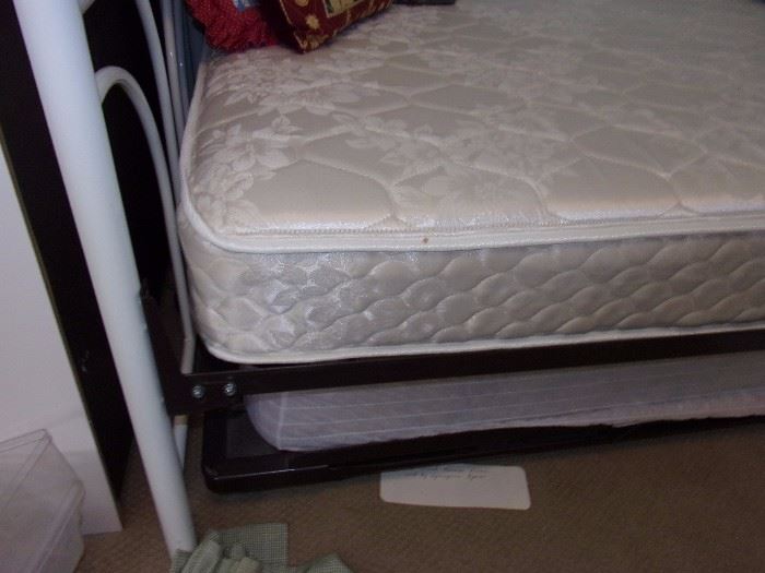 One of two Trundle day beds Iron white ornate with two twin mattresses
