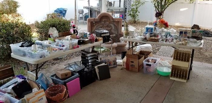 The patio is packed with storage items, tons of kitchen utensils and cooking items, and more.  And, yes, that is a great fountain in the background that is also for sale!