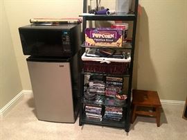 Mini-fridge and microwave, dvds, shelves, small stool.