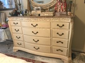 Bob Mackie Home Collection Ivory & Gilt Twelve Drawer Chest with Café-Au-Lait Marble Top & Acanthus Leaf Detail  (70” x 42.5” x 21”)   1,275.—