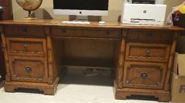 Tommy Bahama wood desk. 4 drawers and 2 cabinets that includes file hanging.