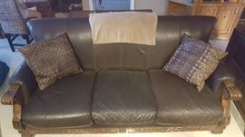 Oversized chocolate brown leather couch with detailed wood accents. The cushions clip into the base so they don't move around.