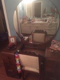 Antique wooden retro art deco style vanity, chair and mirror.