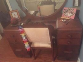 Antique wooden retro art deco style vanity, mirror and chair.