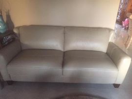 Cream colored leather couch. Seats 3 people - it's a full couch and not a love seat. Never used as it's still n the "formal living room". Matching chair optional.