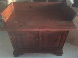 Antique wooden dry sink with flap open.