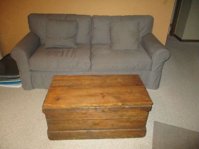 Sofa and antique wood trunk