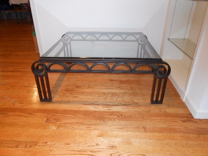 Glass/metal coffee table with arched/swirl design, straight legs.  4'X4'