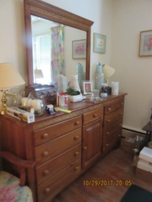 Maple chest with mirror has nine drawers and a cabinet. 