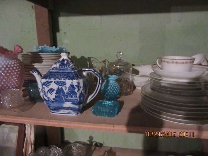 Willow teapots.  on the right is another set of dishes. 