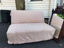Pretty & practical love seat/settee.  White muslin upholstery under a removable striped slipcover.