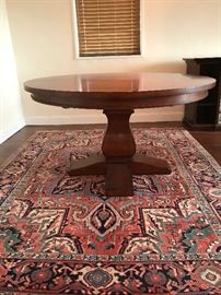 Restoration Hardware pedestal table and gorgeous Persian rug.