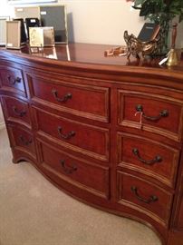 This good-looking  triple dresser matches the king bed.