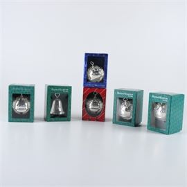 Reed & Barton Annual Silver Plate "Holy Bell" Christmas Ornaments: A collection of annual silver plate ornaments from the Holy Bell Collection by Reed & Barton. This selection includes five bells from 1996, 2000, 2003, 2004, and 2005. The lot also includes a single 2006 bell from Reed & Barton’s Silverplate Christmas Bell Collection. Each ornament comes in the original packaging marked, “Reed & Barton Since 1824”.