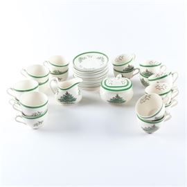 Spode "Christmas Tree" Tea Service Set: A tea service set in the Spode Christmas Tree pattern. These cream dishes are decorated with wide green bands and depict a colorful Christmas tree. There are thirty-eight total items including teacups and saucers and a creamer and lidded sugar bowl set. These porcelain dishes are marked to the underside “Spode England Christmas Tree”.