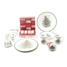 Spode "Christmas Tree" Porcelain Tableware: A collection of Spode Christmas Tree tableware. This cream porcelain is decorated with a wide green band and depicts a colorful Christmas tree. Included are a circular cork-backed trivet, a two-tiered serving tray with two graduated round plates, a bell, two sets of salt and pepper shakers, a potpourri ball, and two handled mugs.Also included is a set of square cork-backed coasters marked “Pimpernel”. The porcelain dishes are marked to the underside “Spode England Christmas Tree”.