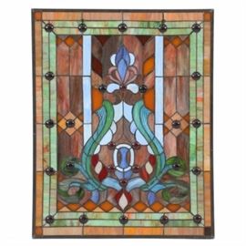 Stained Glass Hanging Window Panel: A stained glass hanging window panel. This panel features an abstract foliate central design, with rectangular and diamond shaped accents and amber beads within a green and orange slag glass border.