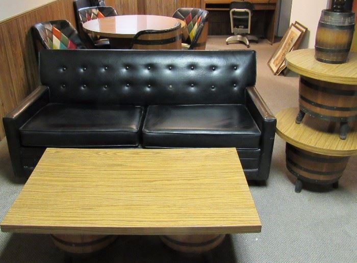 Black vinyl two seater love seat, barrel end and coffee tables, barrel lamps