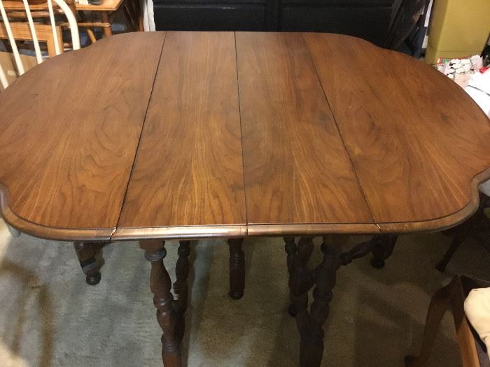 -kitchen table with drop-leaf sides; measures 29 1/2" tall, 42 1/2" wide, and 54 1/2" long with sides up, 20" long with sides down