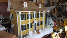 old doll house with many pieces of furniture