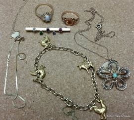 Bracelet is 10 kt gold, Pin with colored stones is 10 kt gold, Pendant with opal in center is 10 kt gold