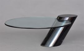 Modern Glass Top Coffee Table	
with cantilevered oval shaped glass
51" wide x 16 1/2" high x 34" deep
circa 1970   Bid on-line November 10th -15th at www.fairfieldauction.com