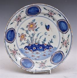 Delft Charger	
decorated with bird and flowers
13 3/4" diameter
18th century   Bid on-line November 10th -15th at www.fairfieldauction.com