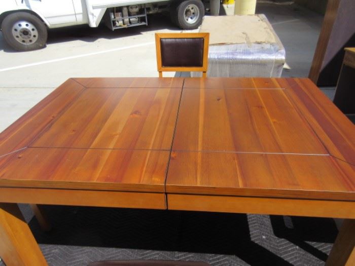 Gorgeous solid wood with beautiful planks showing on the top of the table, opens for an extension leaf; includes 4 chairs with leather seats and backs