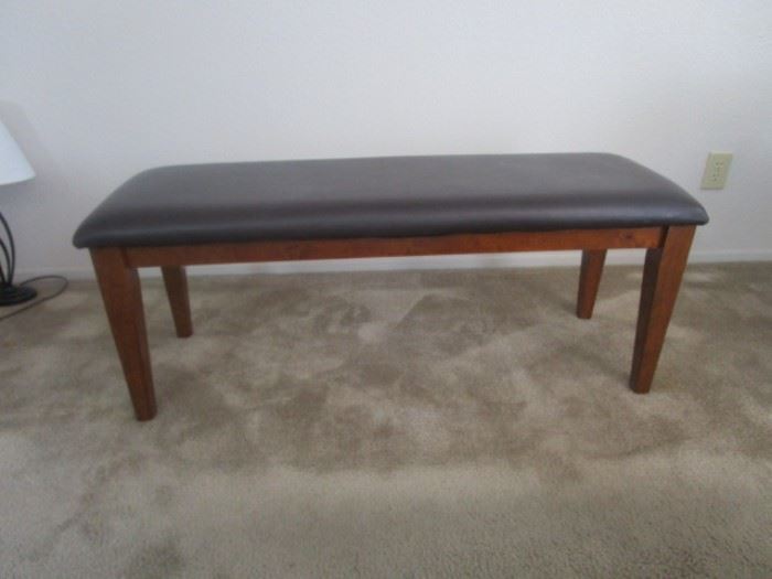 Elegant bench with solid wood and leather seat covering, brown