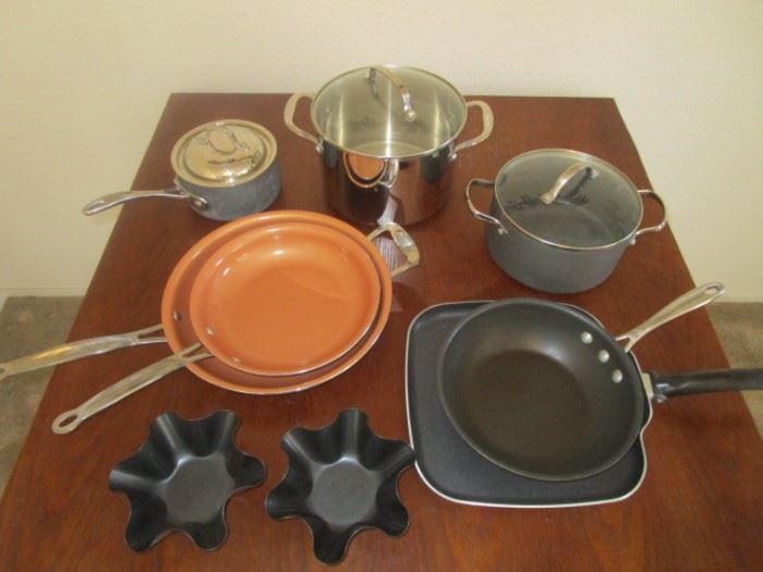 Red Copper pans with some high end sauce pans, tostada shell makers, a grill and a wok