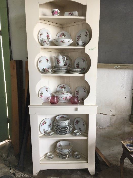 Here is corner cabinet with porcelain set