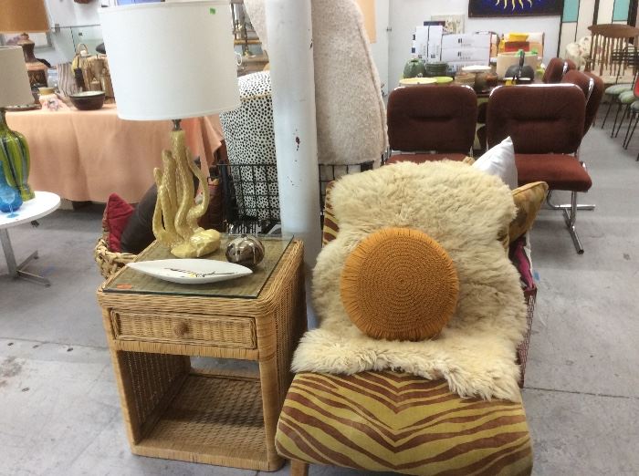 Zebra slipper chair with sheepskin, wicker side table, cactus lamp