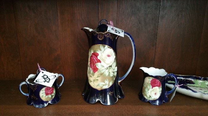 Antique tea pot with creamer and sugar.