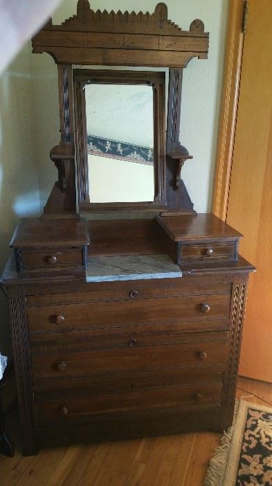 Antique Eastlake Victorian mirrored dresser with marble inset.