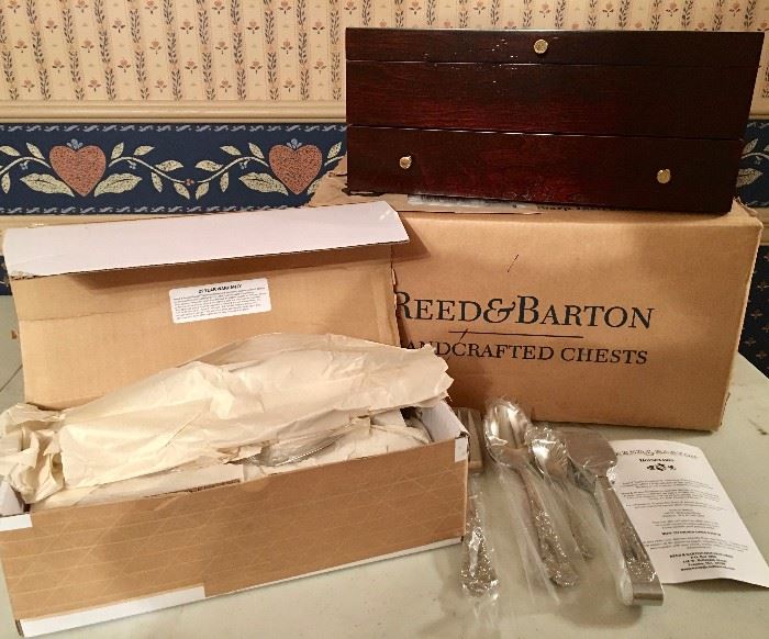 Reed & Barton 110-piece setting for 12, all wrapped in box, left, and Reed & Barton flatware chest with box. There are four such Reed & Barton sets in different patterns.