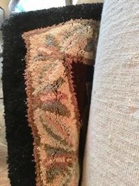 Peek at the edge of one of several wool rugs still new in packaging